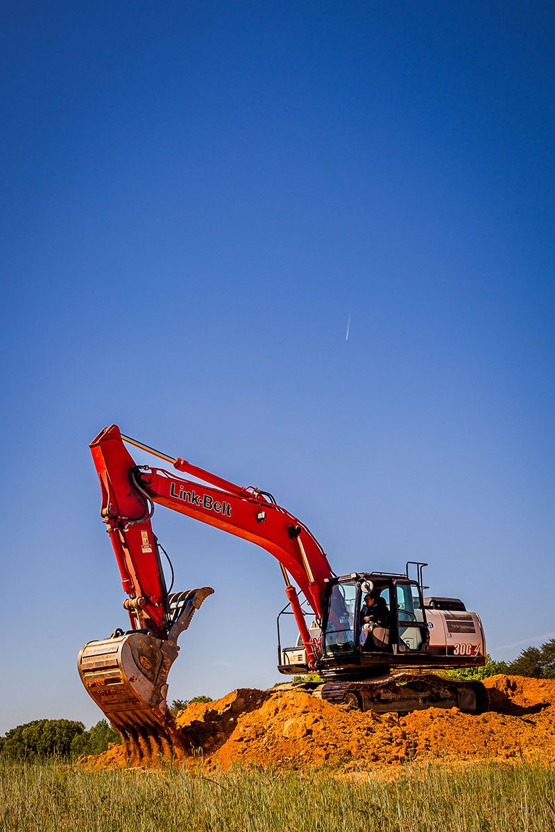 Sellers Brothers Link-Belt excavator on a jobsite under clear blue sky